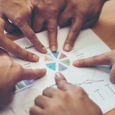 Group of business partners discussing ideas analysis and plannin Group of business partners discussing ideas analysis and planning work in office.